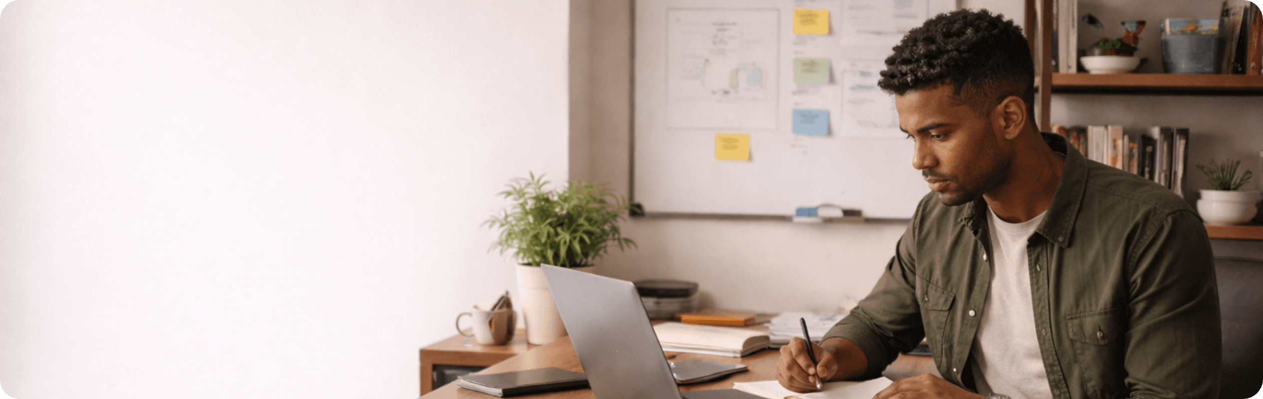 Founder at a desk with laptop and workspace